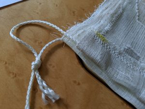 Reusable produce bag tutorial: Tie the ends of the cord.