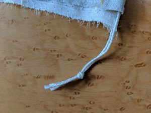 Reusable produce bag tutorial: Tie the ends of the cord.