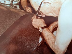 My grandfather cutting out tin