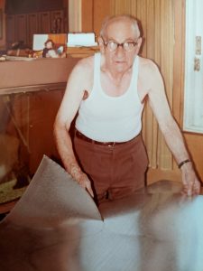 My grandfather cutting out tin