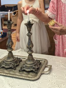 My mom lighting Shabbat candles