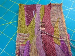 Hand stitching a fabric collage