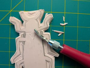Carving a beetle lino stamp
